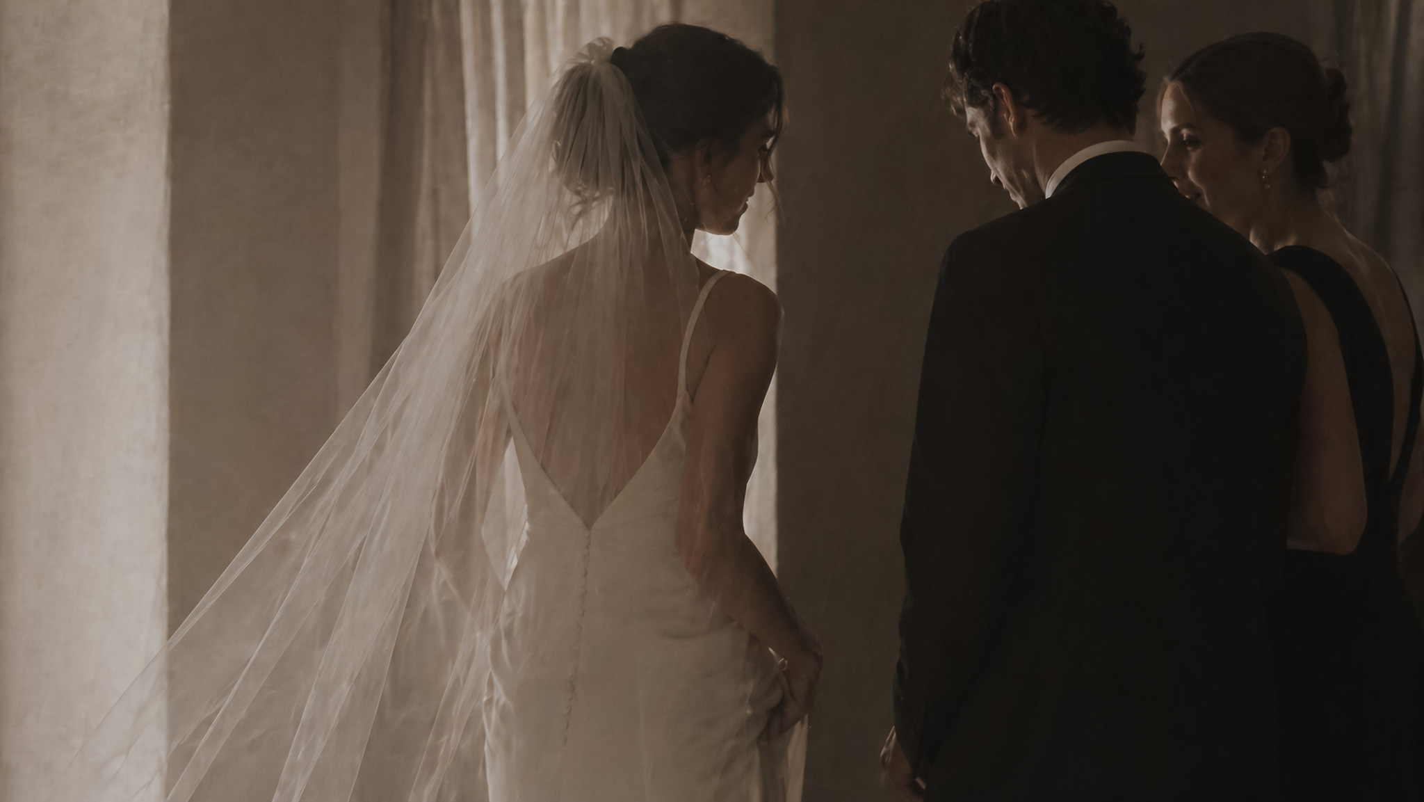 Quiet interaction between bride and guests during an elegant private wedding