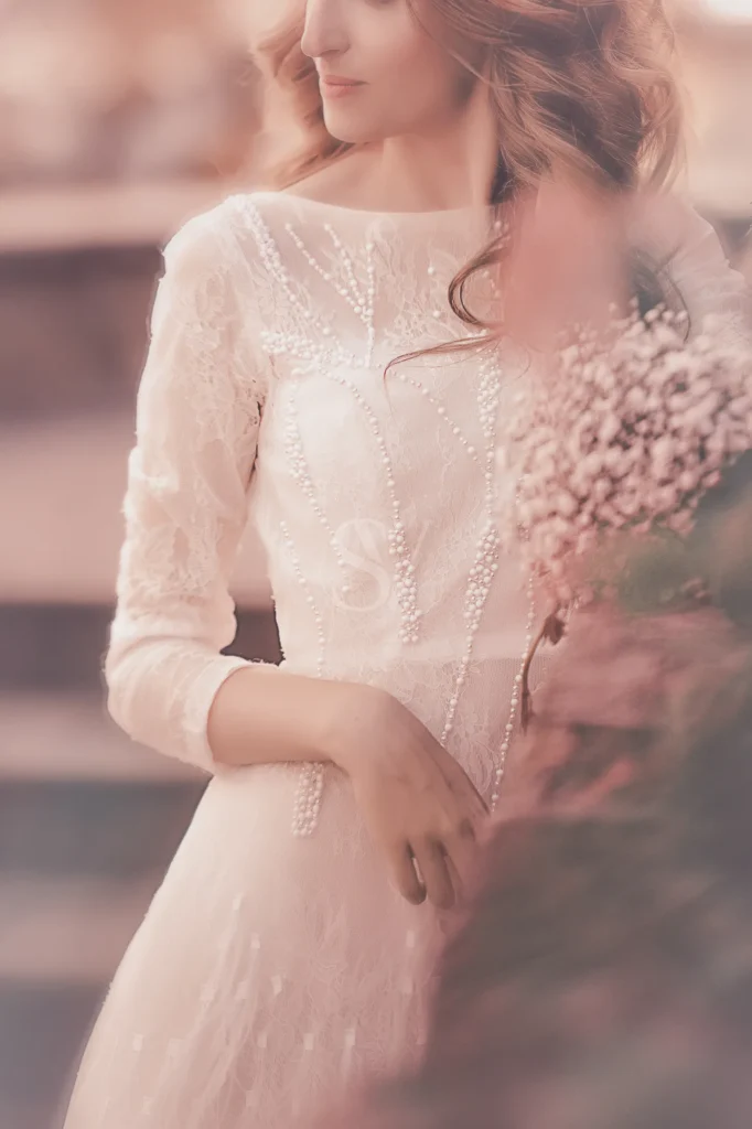 Bride in a beaded wedding dress holding a bouquet