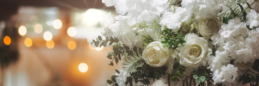 White floral arrangement with soft reception lights