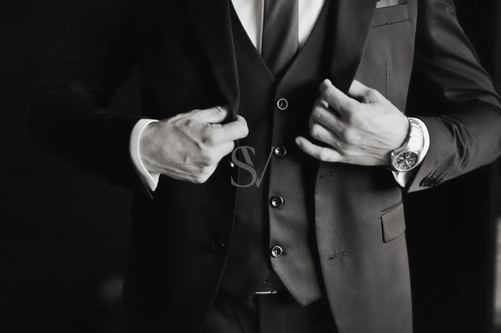 Groom adjusting his jacket before the wedding